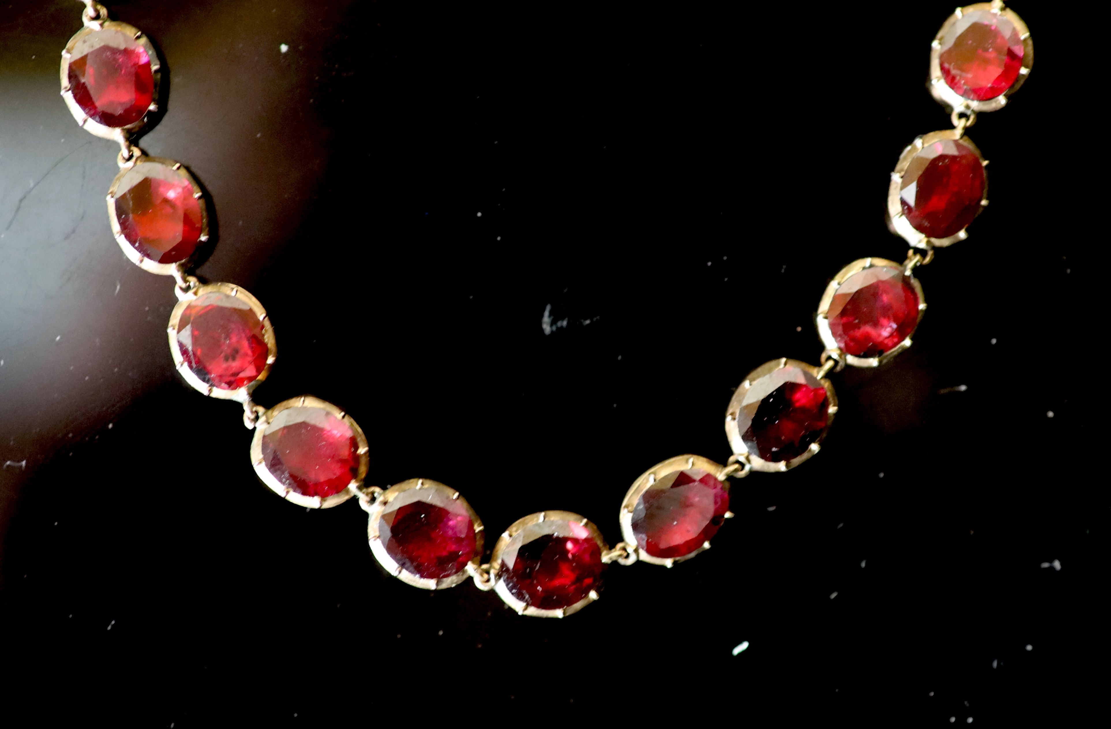 An early 19th century gold and garnet set necklace,